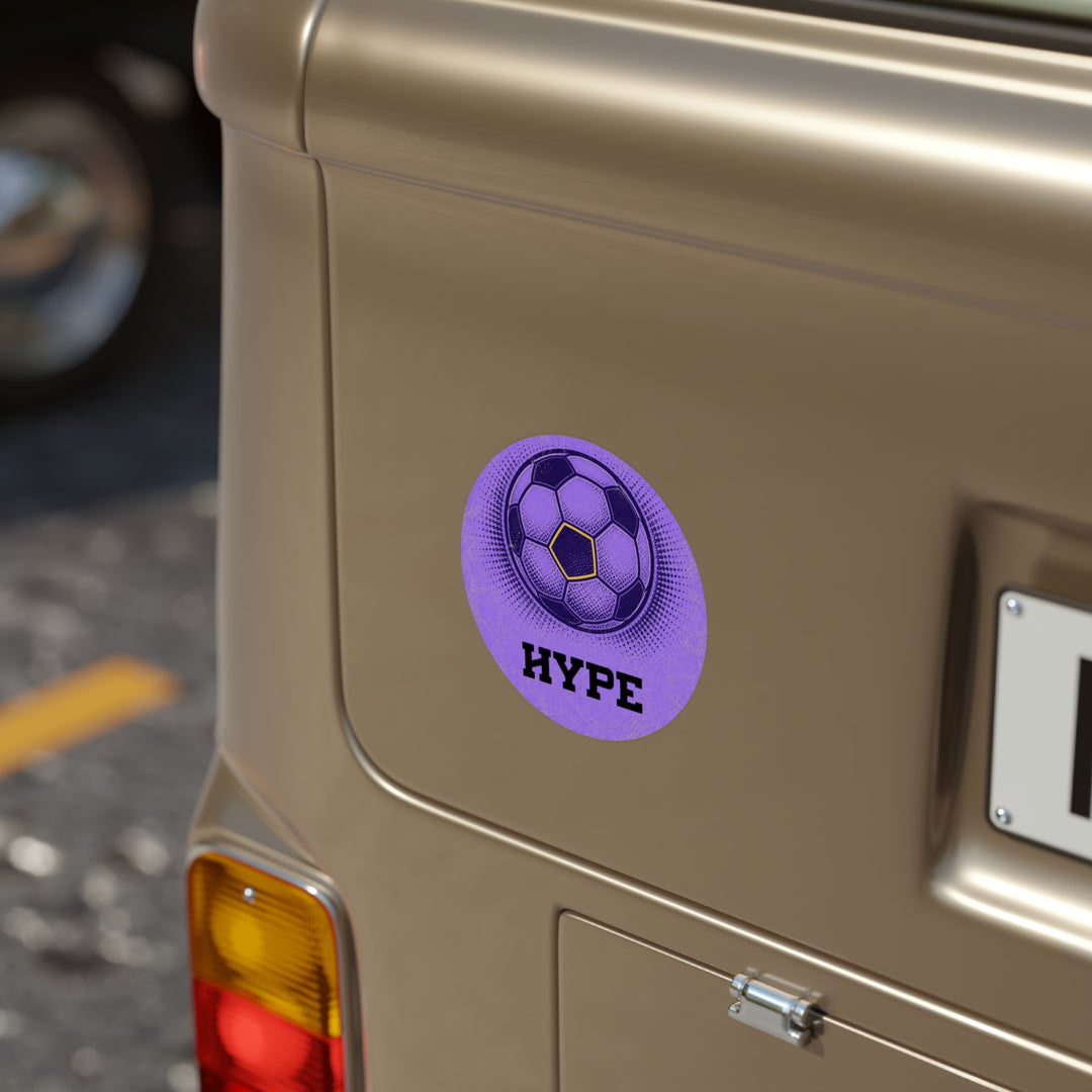 A round purple sticker with a soccer ball graphic and the word &