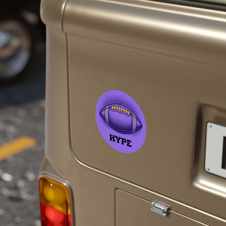 A circular purple sticker featuring a football graphic and the word &