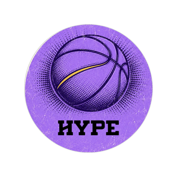 A circular purple sticker or patch featuring a stylized basketball graphic with a yellow accent line, halftone dot patterns, and the word &