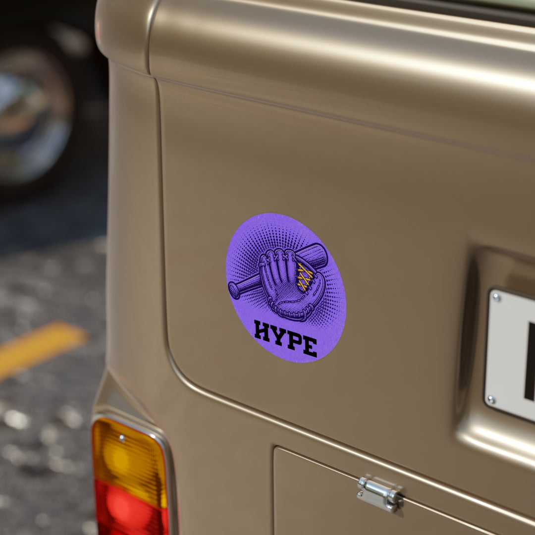 A circular purple sticker on the side of a metallic gold vehicle, featuring a baseball glove and bat graphic with the word &