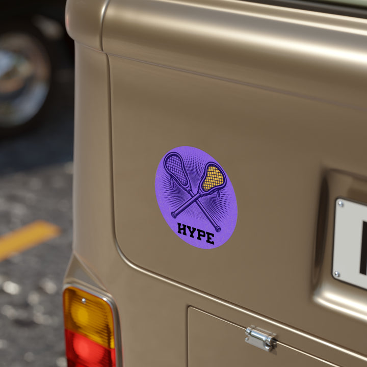 A circular purple sticker with crossed lacrosse sticks and the word &