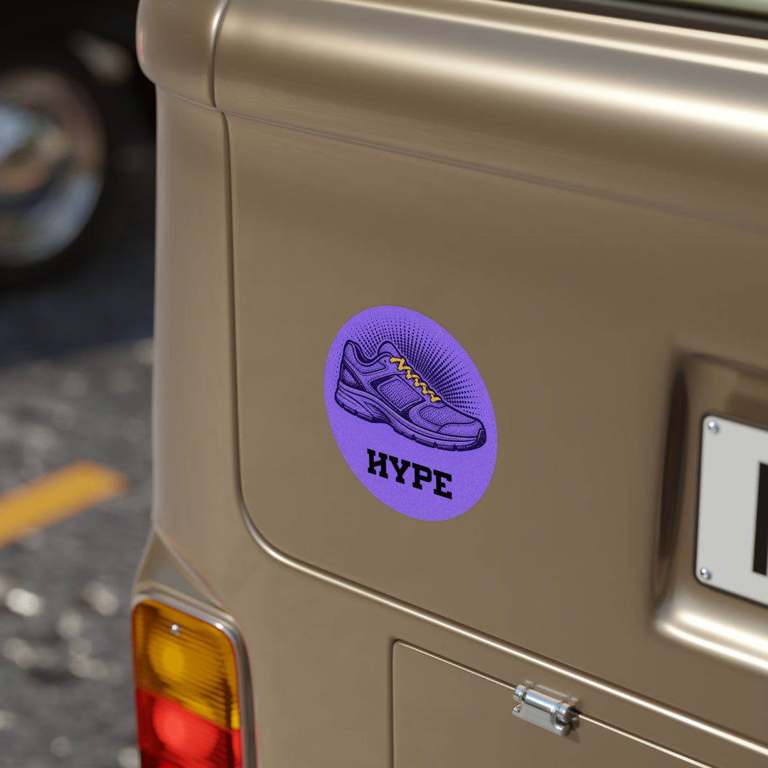 A round purple sticker with a graphic of a sneaker and the word &
