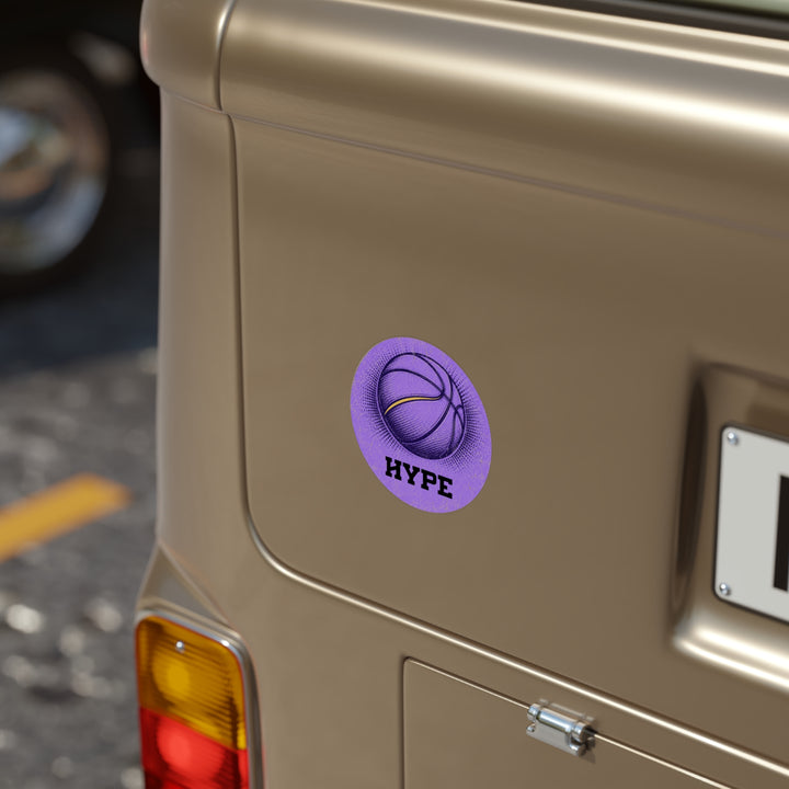 A circular purple sticker with a basketball graphic and the word &