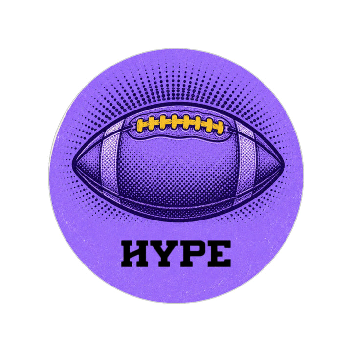 A circular purple sticker or coaster featuring a stylized football graphic with yellow laces, a halftone pattern, the word &