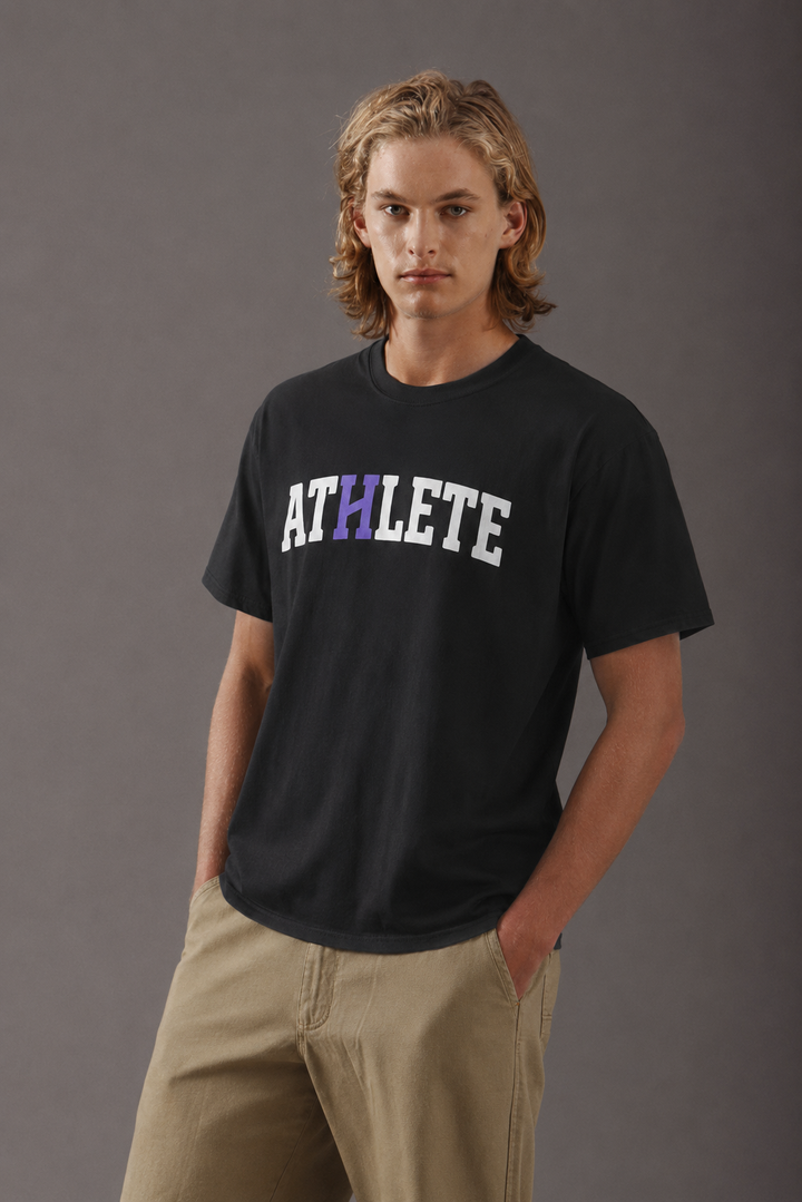A man wearing a black short-sleeve t-shirt with &