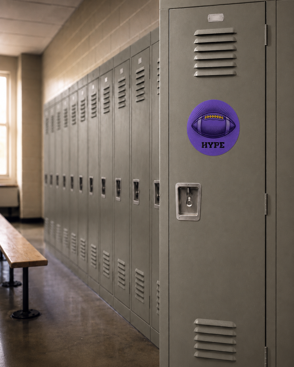 A purple circular sticker with a football graphic and the text 'HYPE' is shown on a gray metal school locker in a hallway.