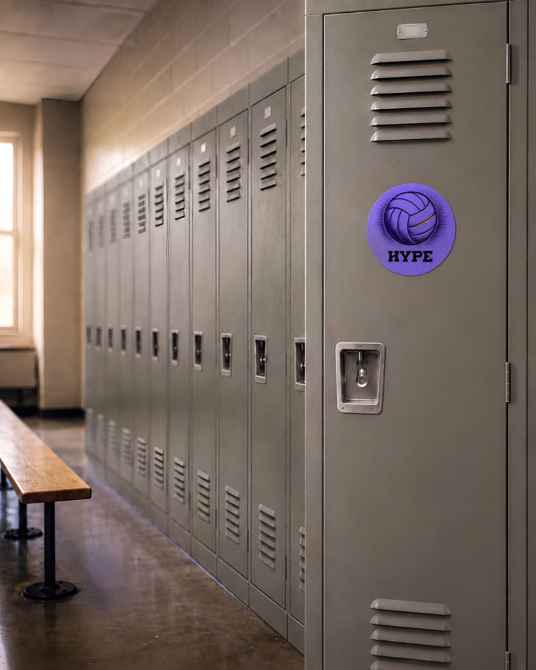 A row of gray metal school lockers in a hallway, with a purple circular decal featuring a volleyball graphic and the word &